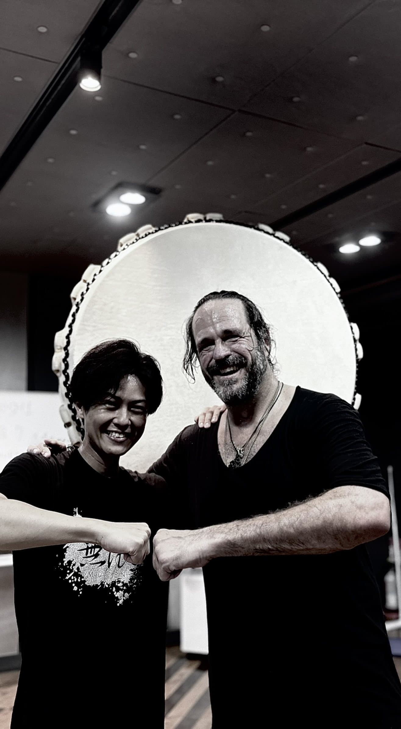 Dustin and his taiko teacher in front of the great drum