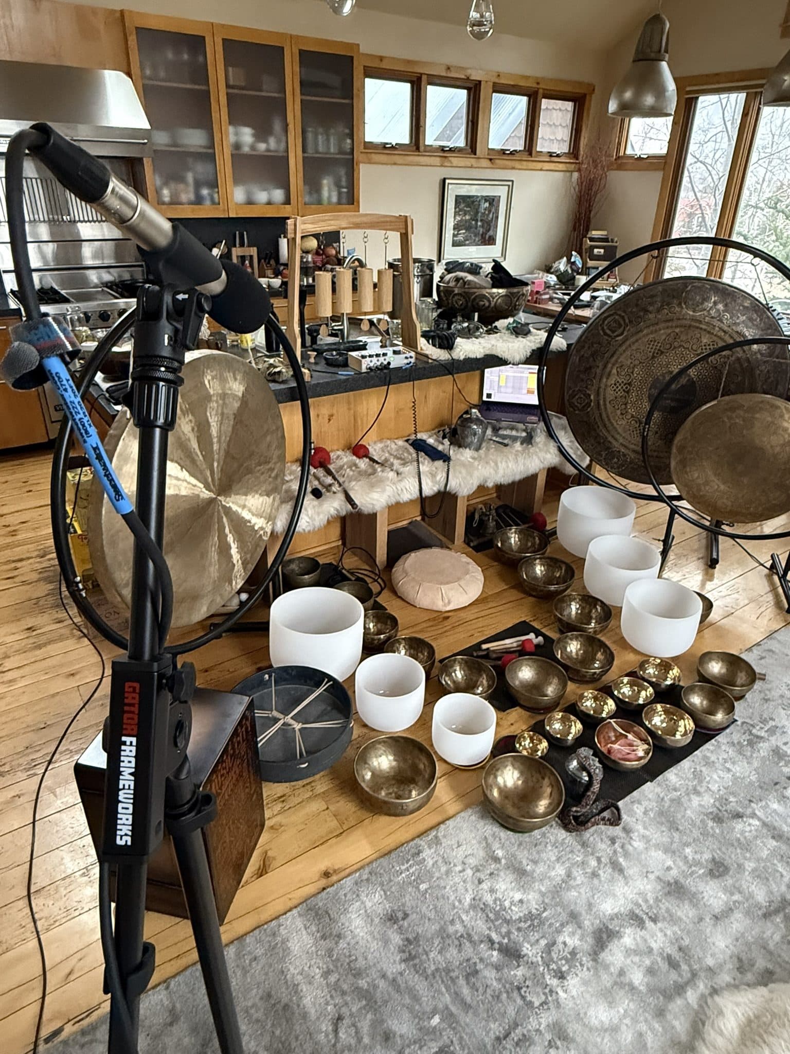 Dustin Wells’s live sound ceremony rig: gongs, bowls, drums, and electronics set up for a room