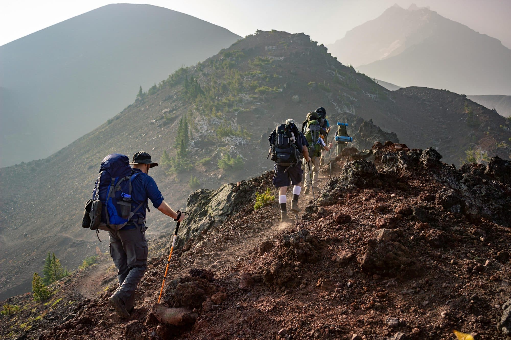 Hikers ascending a mountain ridge