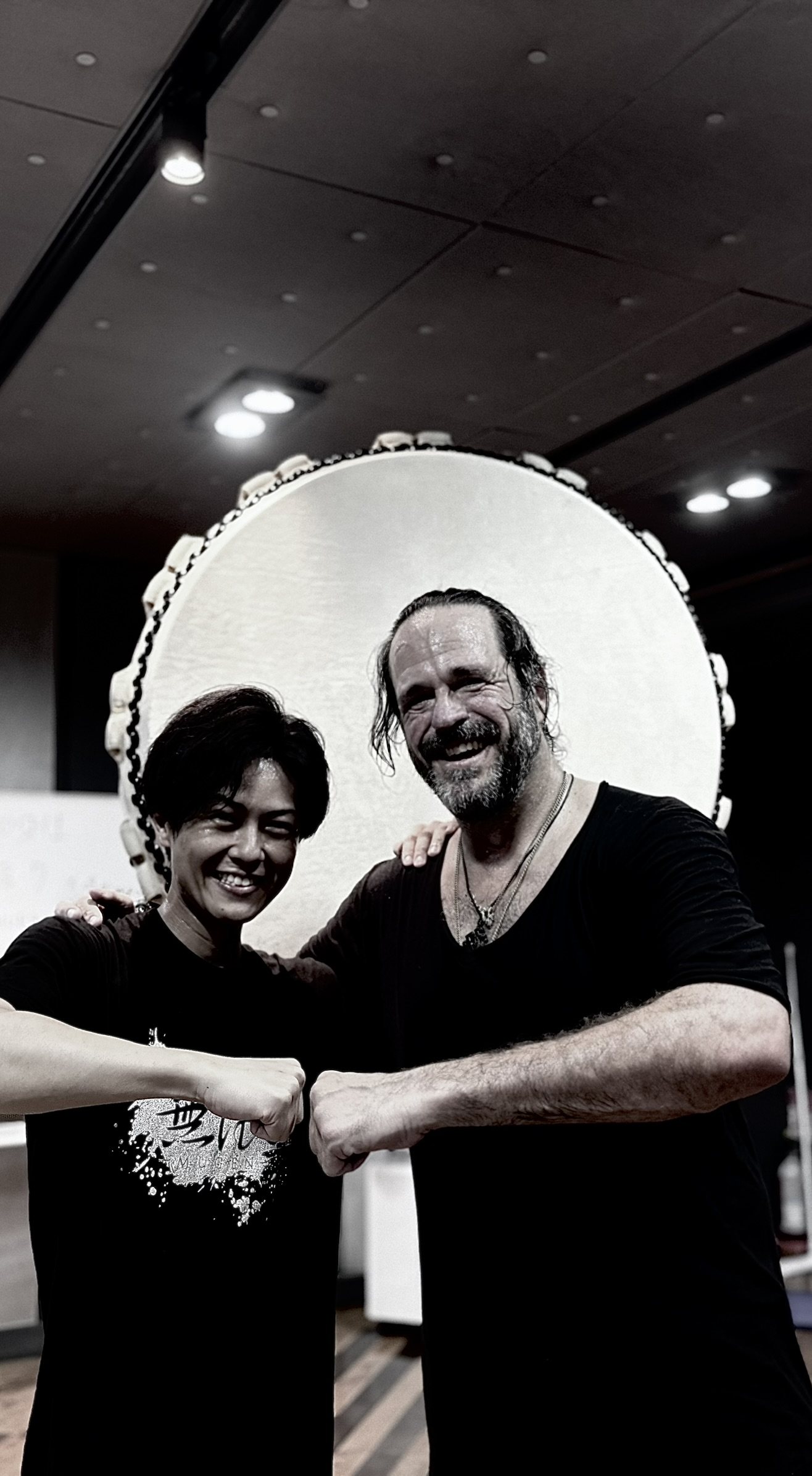 Dustin and his taiko teacher in front of the great drum